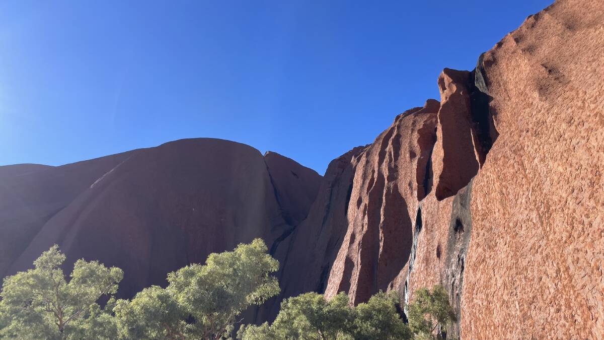 The red hues of Uluru is a stark but beautiful contrast to the blue sky. Picture: Emily Clooney