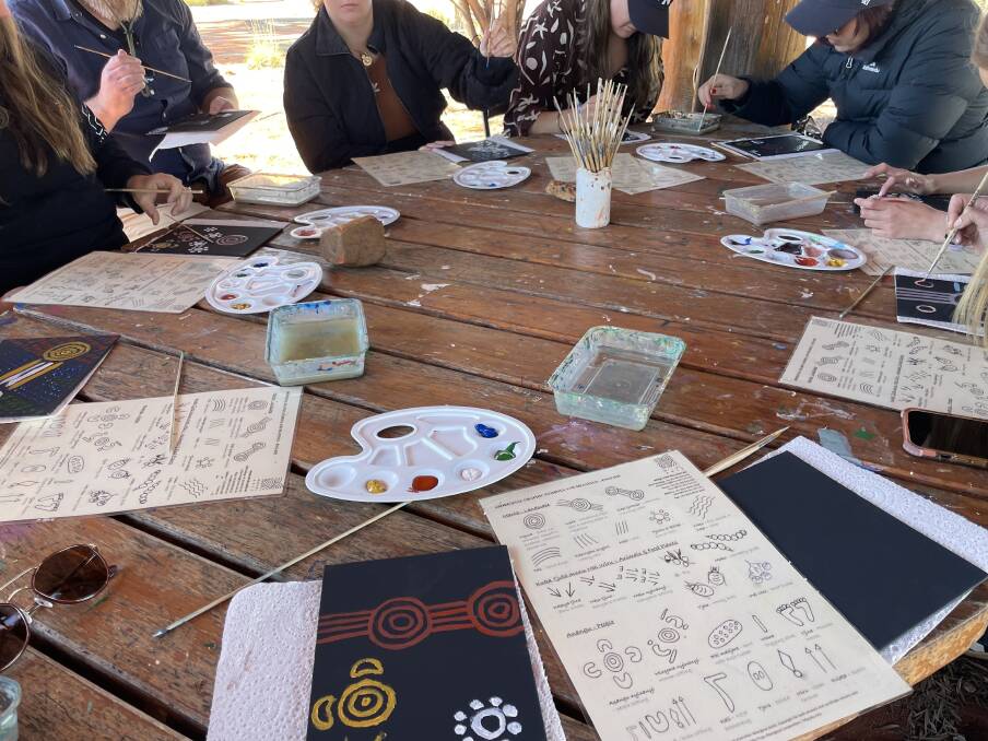 Maruku Arts offers dot-painting workshops guided by Anangu. Picture: Emily Clooney