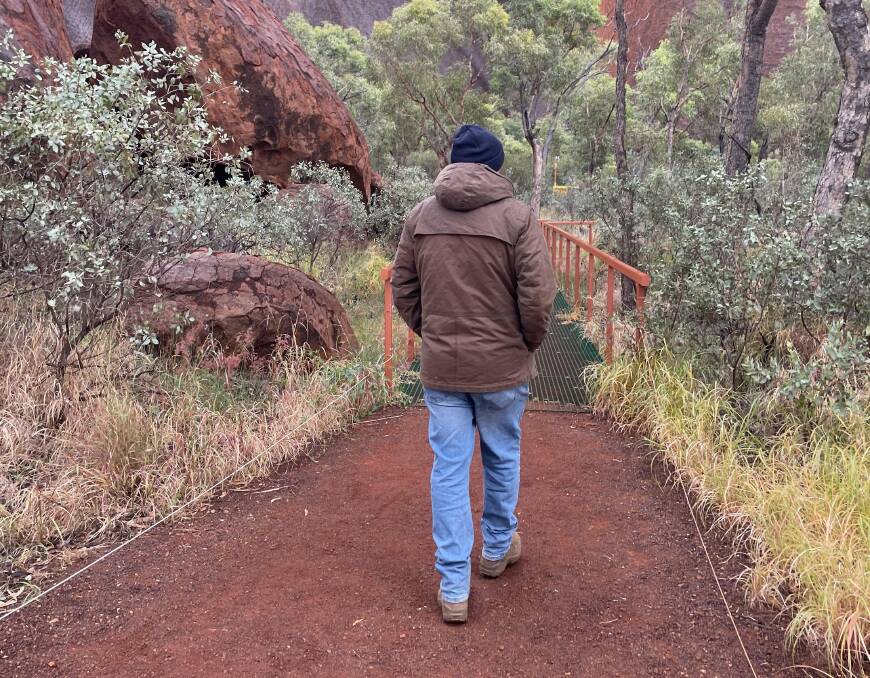 TJ leads the group to Mutitjulu Waterhole at Uluru. TJ leads the group to Mutitjulu Waterhole at Uluru.
