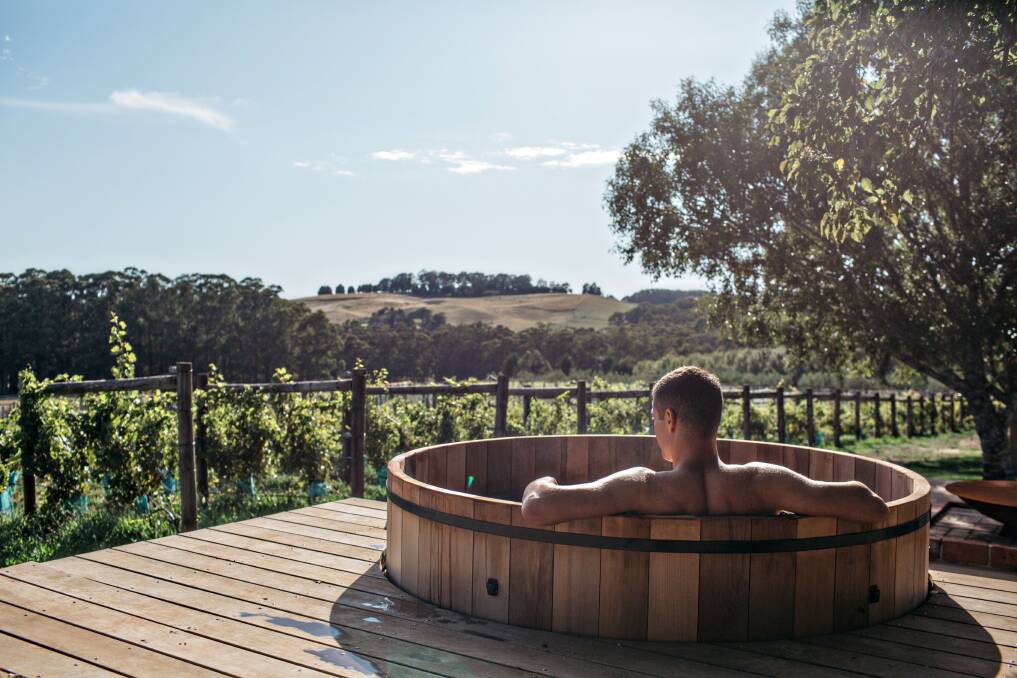 An outdoor hot tub overlooks the vines.
