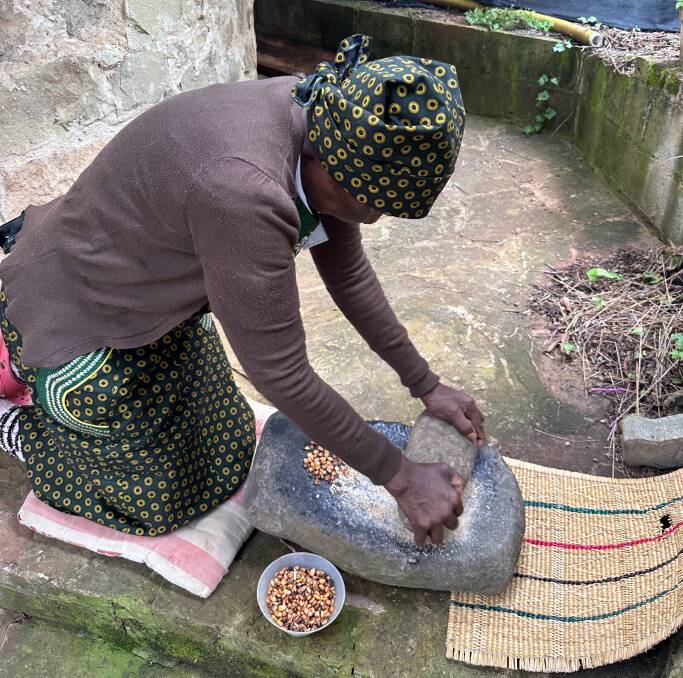 Learning how to stone-grind corn at Bothobapelo lodge. Picture by Laura Waters