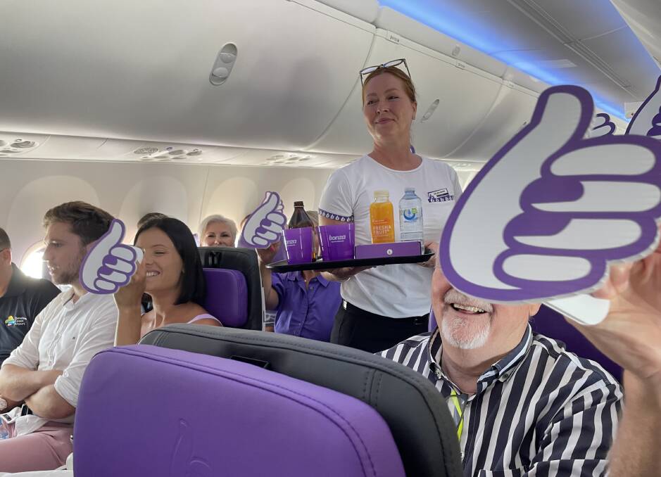 A cabin crew member delivers food on board Bonza's maiden flight. Picture: Sarah Maguire A cabin crew member delivers food on board Bonza's maiden flight. Picture: Sarah Maguire