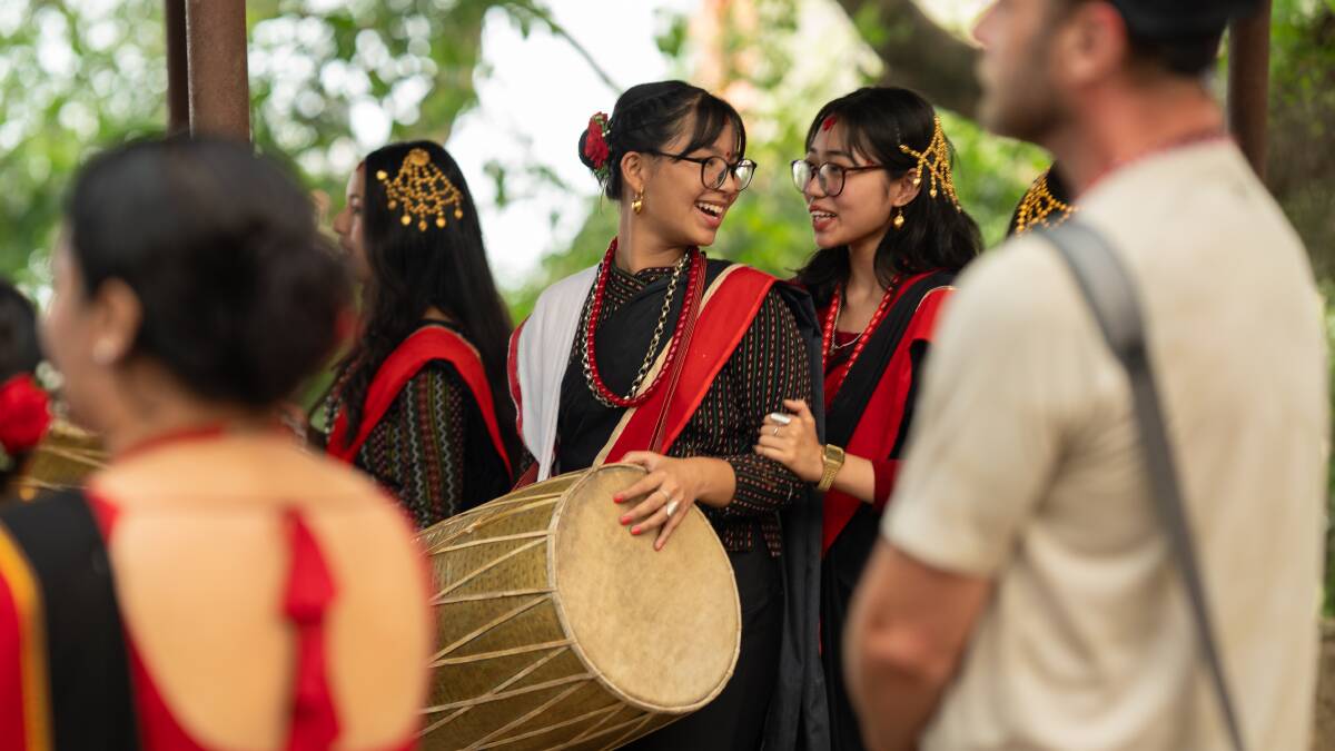 Villagers welcome guests with music.