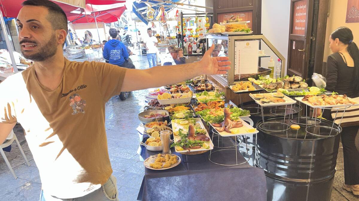 An energetic vendor at Palermo's food and fish market. Picture by Sarah Maguire