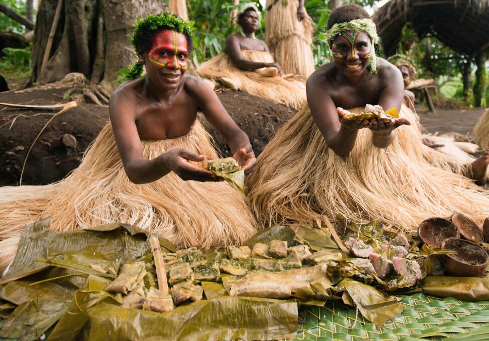 Women serving laplap in Vanuatu. Women serving laplap in Vanuatu.