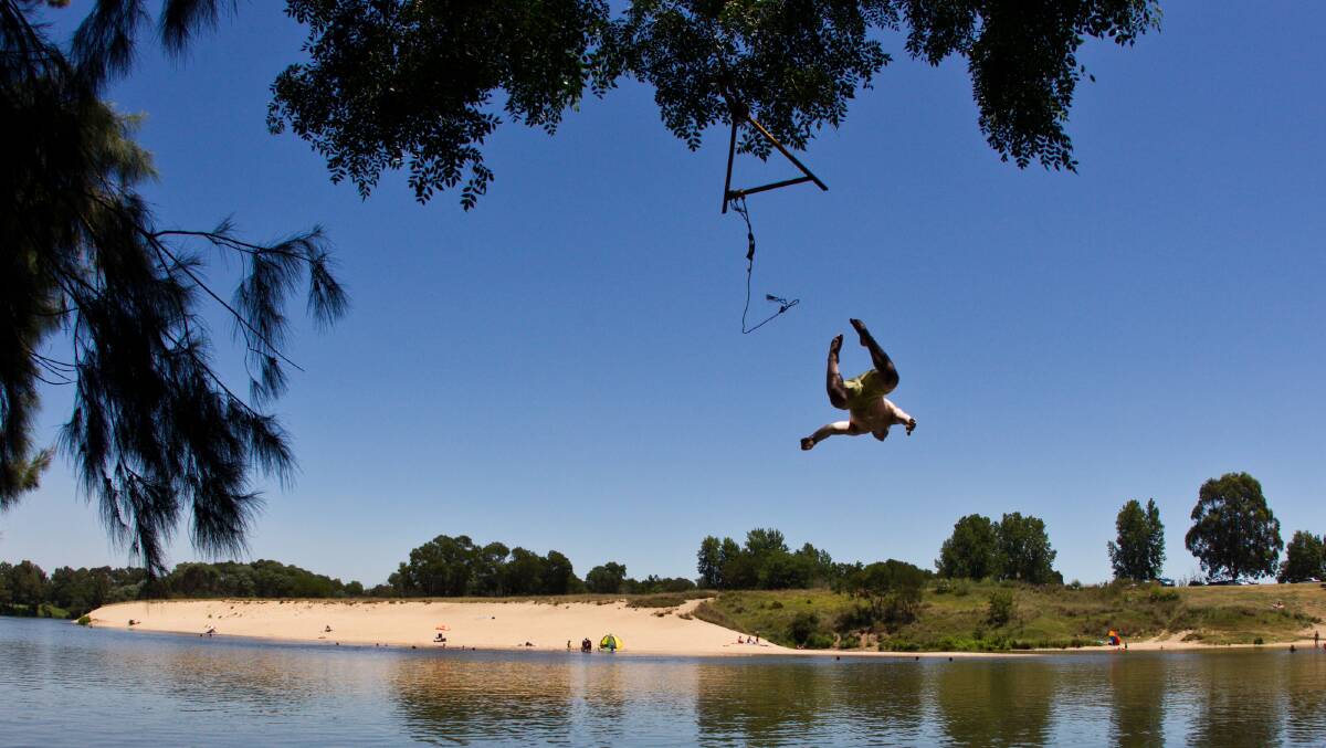 A local dives into the Hawkesbury River at Windsor. Picture: Geoff Jones.