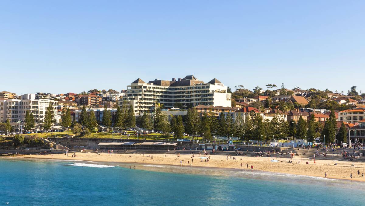 The landmark L-shaped hotel is across the road from the beach. The landmark L-shaped hotel is across the road from the beach.