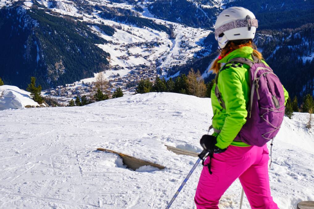 A skier looks down towards Corvara mountain village in the Italian Dolomites. Picture: Getty Images A skier looks down towards Corvara mountain village in the Italian Dolomites. Picture: Getty Images