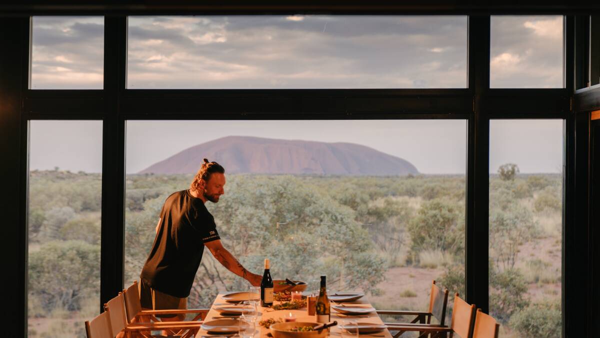 Dinner is served in full view of Uluru. Picture by Michael Peters Dinner is served in full view of Uluru. Picture by Michael Peters