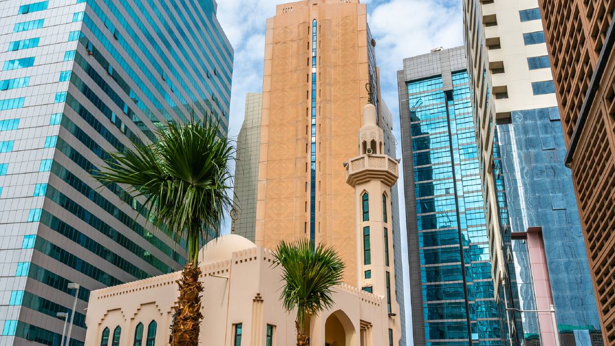 A mosque between modern skyscrapers. A mosque between modern skyscrapers.