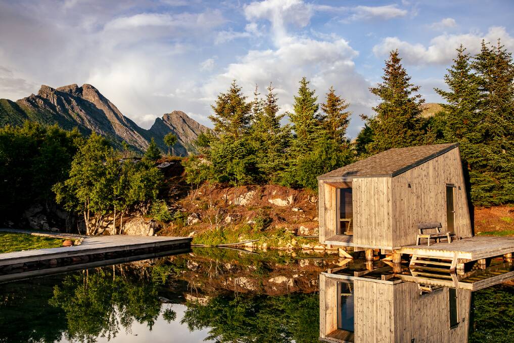 Buildings on Manshausen Island under the late-night sun.
