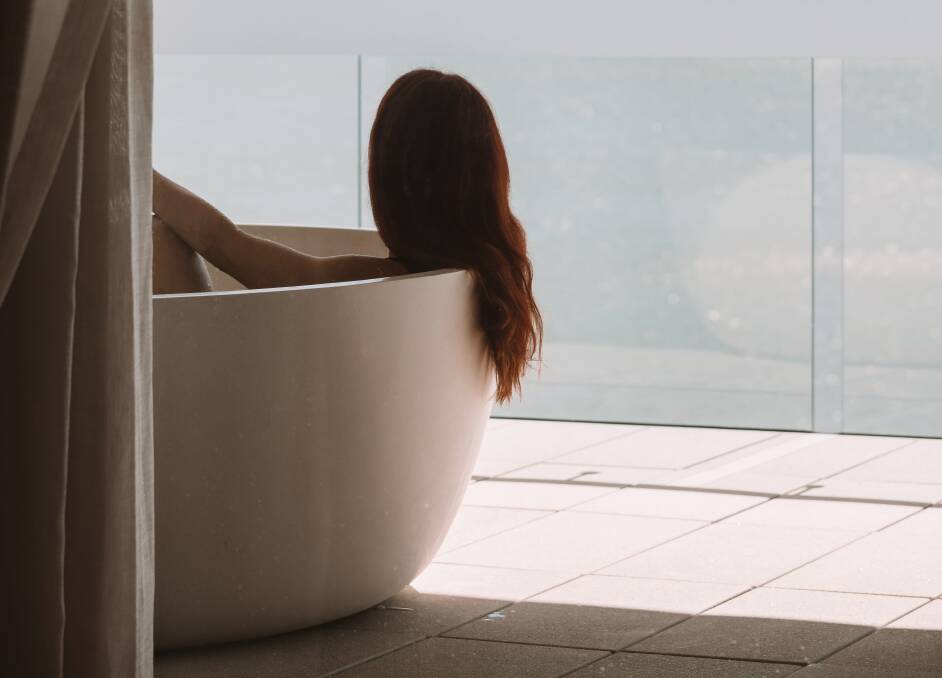 A balcony with a bathtub.
