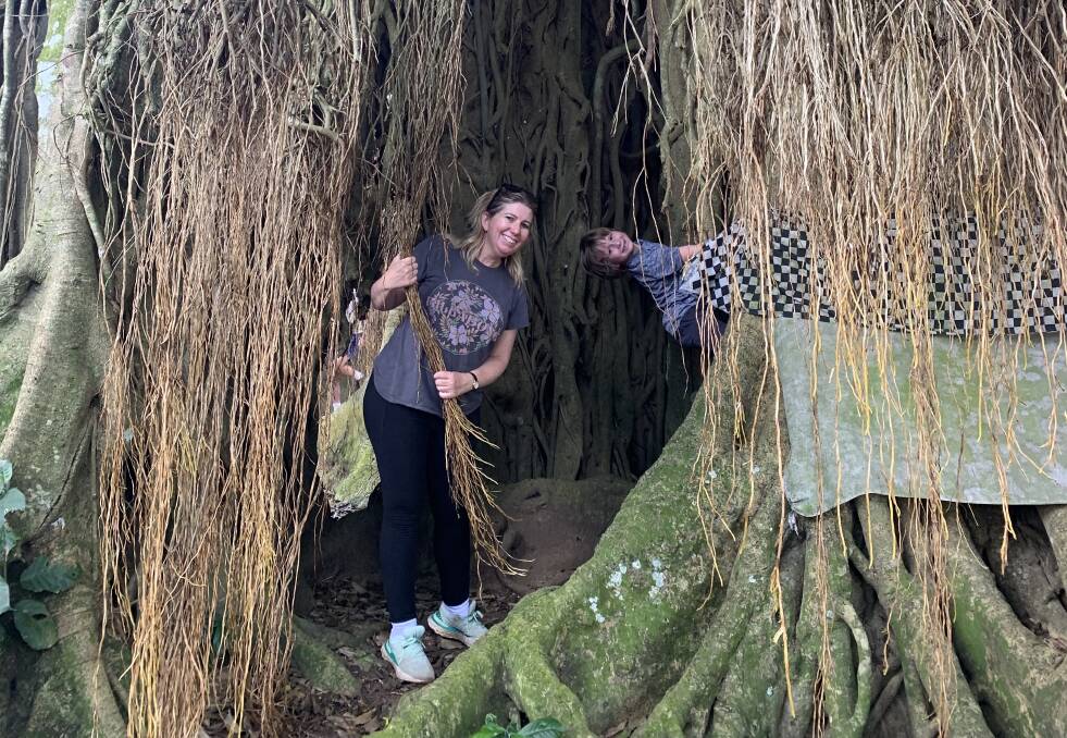 The writer and her son exploring a centuries-old tree. The writer and her son exploring a centuries-old tree.