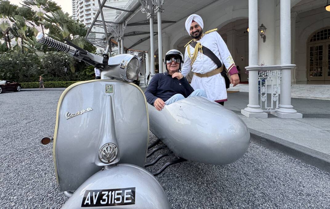 The writer stops by Raffles for a photo with the doorman. The writer stops by Raffles for a photo with the doorman.