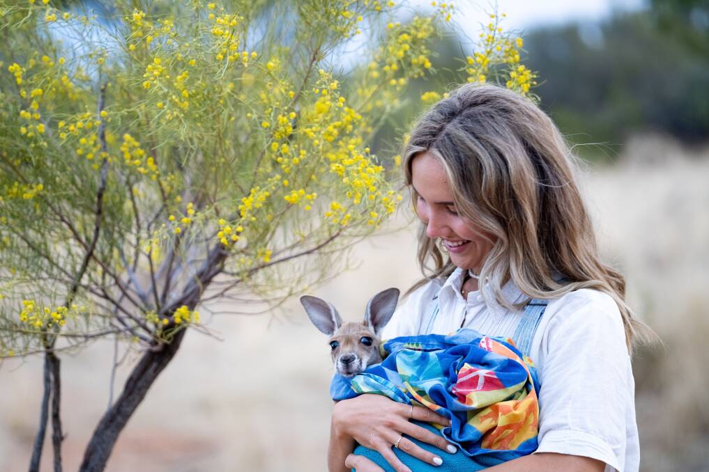 Cuddles at the Kangaroo Sanctuary. Picture: Tourism NT Cuddles at the Kangaroo Sanctuary. Picture: Tourism NT