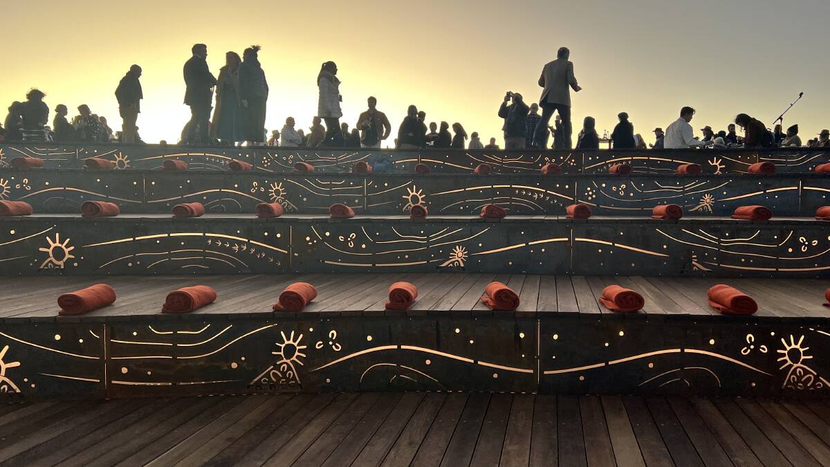 Anangu woman Christine Brumby's backlit artwork on the viewing platform steps where visitors watch the Wintjiri Wiru drone, sound and light show in front of Uluru. Picture: Saffron Howden Anangu woman Christine Brumby's backlit artwork on the viewing platform steps where visitors watch the Wintjiri Wiru drone, sound and light show in front of Uluru. Picture: Saffron Howden