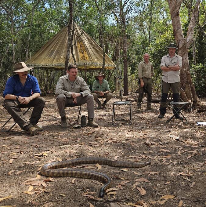 Some of the participants of the Bushcraft Survival Australia course during the bush first aid lesson - with Lucifer, the snake.