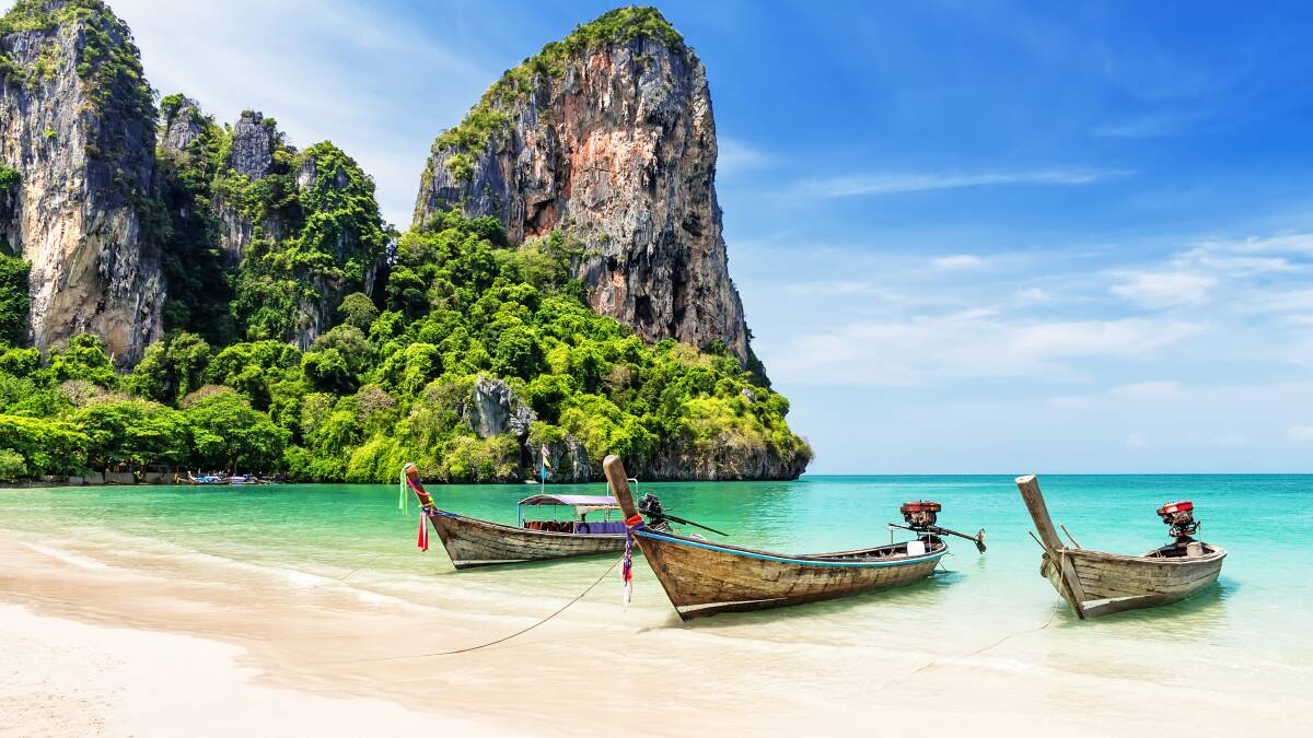Longtail boats on a pristine beach. Picture: Shutterstock Longtail boats on a pristine beach. Picture: Shutterstock