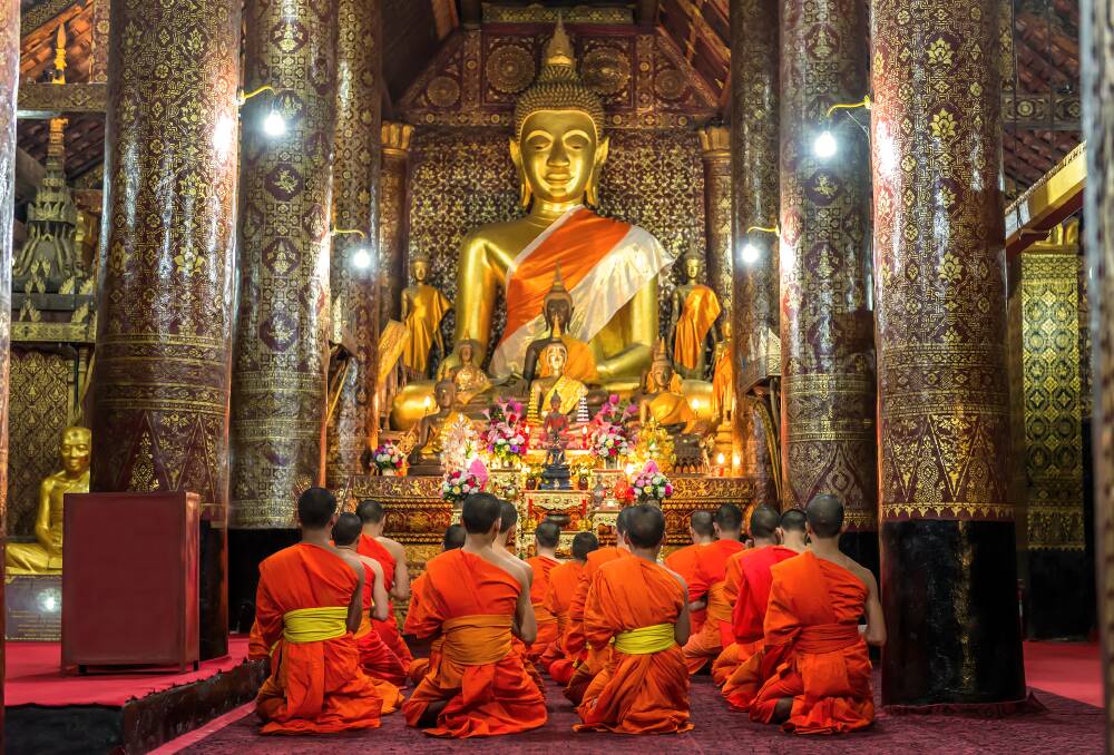 Monks praying at a temple in Luang Prabang. Picture: Shutterstock Monks praying at a temple in Luang Prabang. Picture: Shutterstock