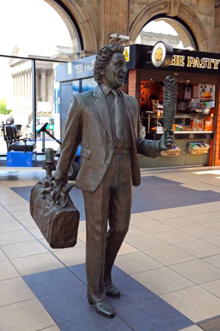 Statue of Ken Dodd with his Diddy Men and Tickling Stick inside Lime Street Railway Station. Picture by Shutterstock