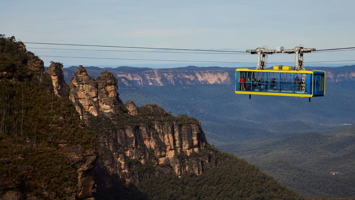 Scenic World's Scenic Cableway against the backdrop of the Three Sisters in the Blue Mountains. Picture by Destination NSW Scenic World's Scenic Cableway against the backdrop of the Three Sisters in the Blue Mountains. Picture by Destination NSW
