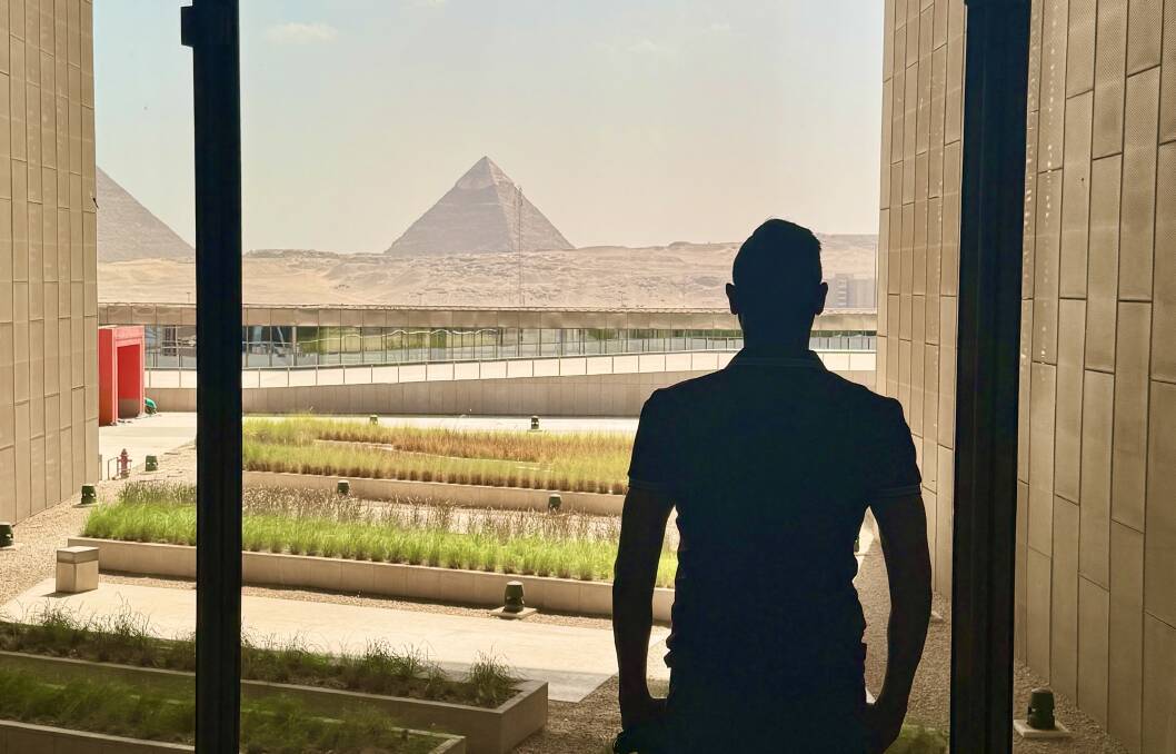 The writer looks out at the Pyramids of Giza.
