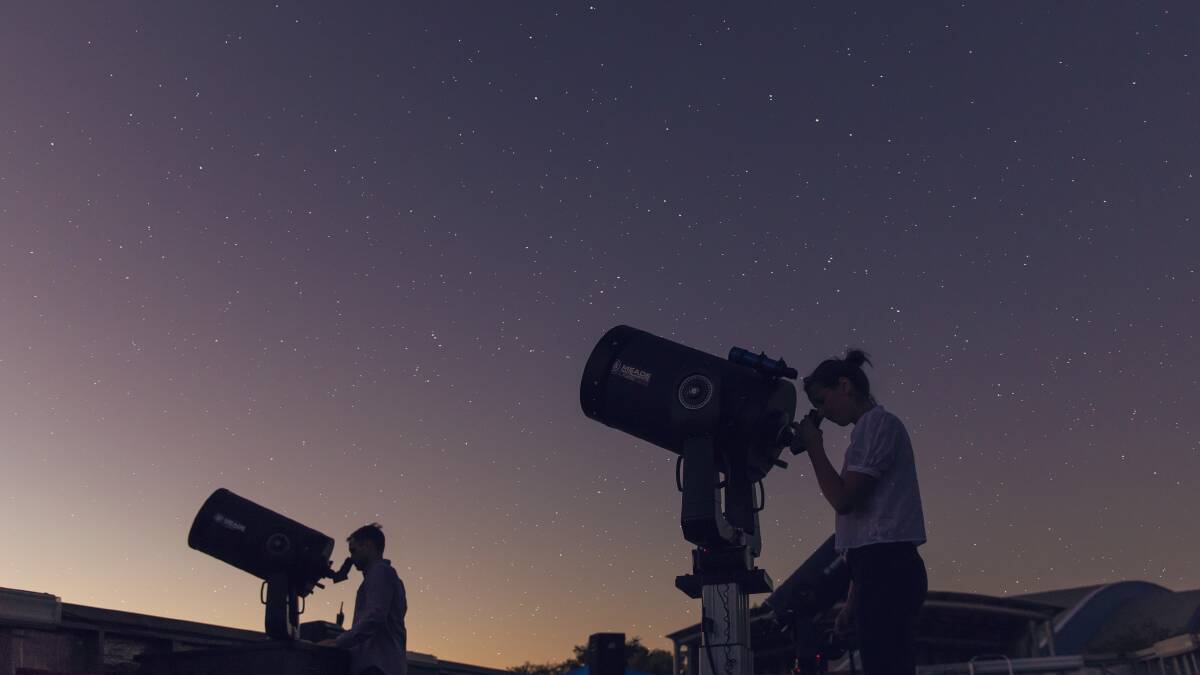 Exploring the night sky at the Cosmos Centre. Picture: Tourism and Events Queensland Exploring the night sky at the Cosmos Centre. Picture: Tourism and Events Queensland
