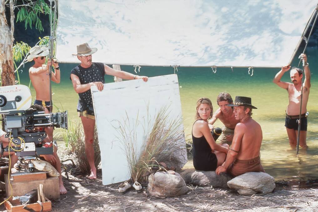 Cast and crew film a Crocodile Dundee scene by a river. Picture supplied Cast and crew film a Crocodile Dundee scene by a river. Picture supplied