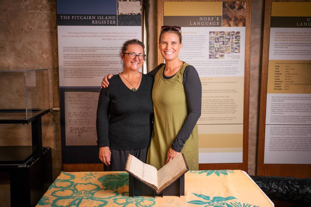 Dr Pauline Reynolds (left) with the Pitcairn Register in the Norfolk Island Museum. Picture supplied