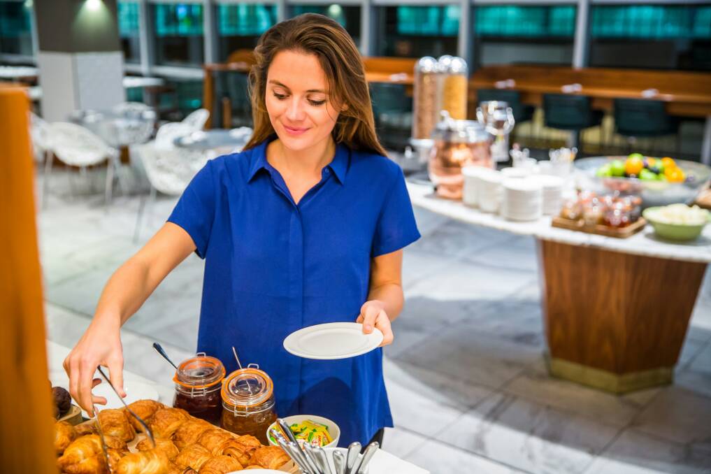 A woman serves herself pastries from a buffet. Picture Unsplash A woman serves herself pastries from a buffet. Picture Unsplash