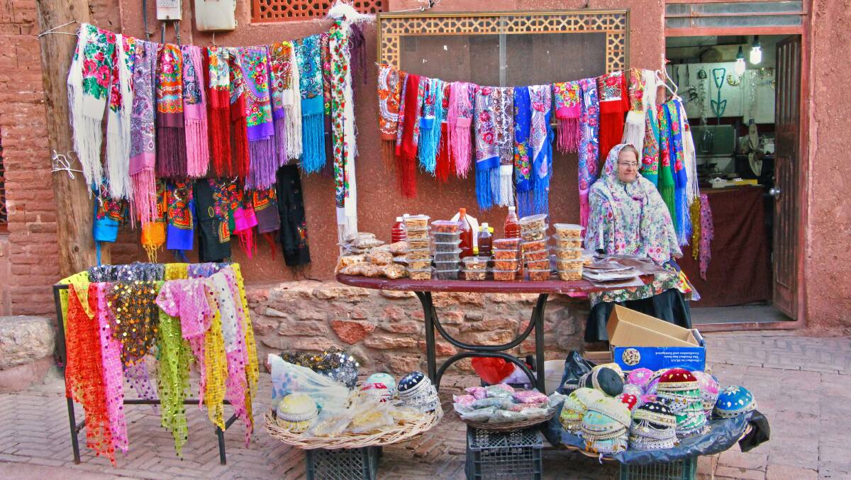 A woman selling textiles in an Abyaneh market. Picture Unsplash/Reyhaneh Ahmadi