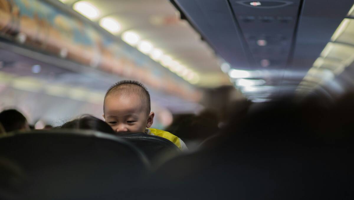 A child peers over a plane seat. Picture Unsplash