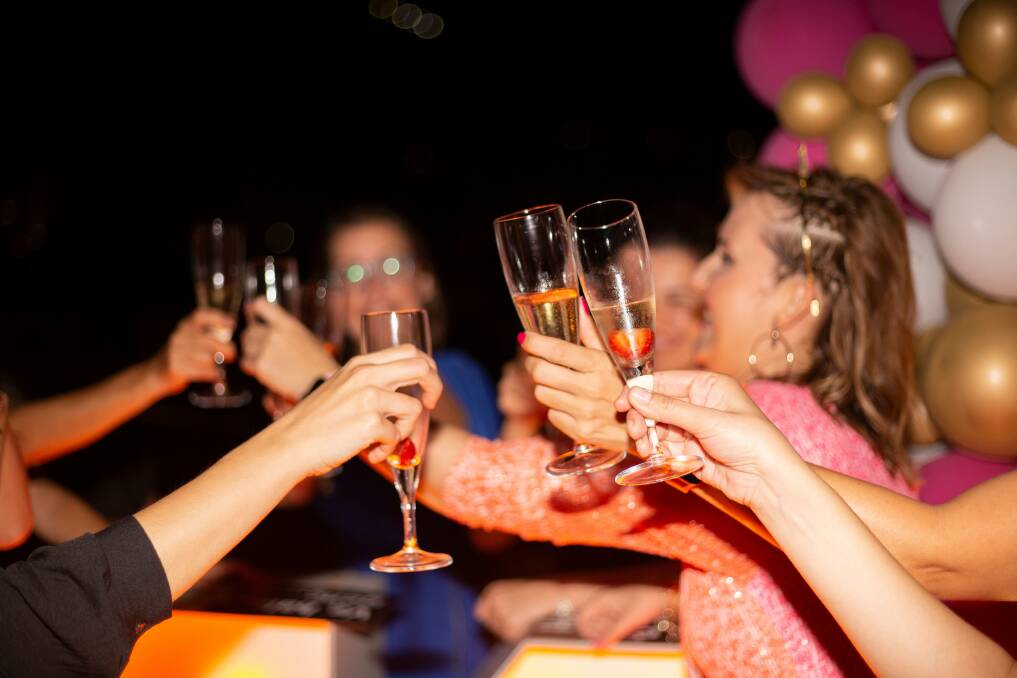 Friends at a party raise a toast. Picture Unsplash