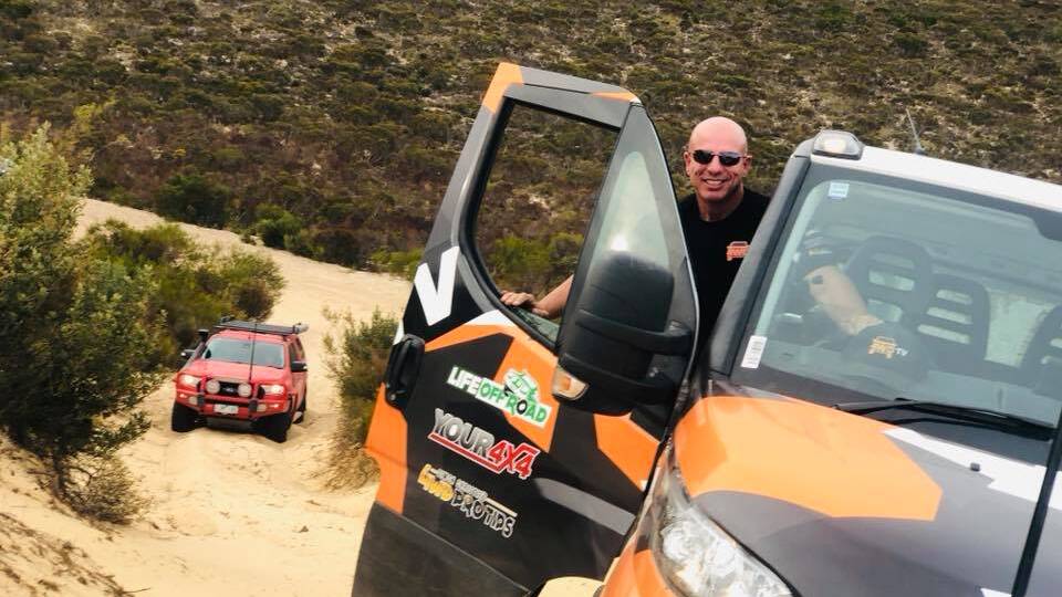 Simon Christie drives up a steep sand dune. Picture supplied