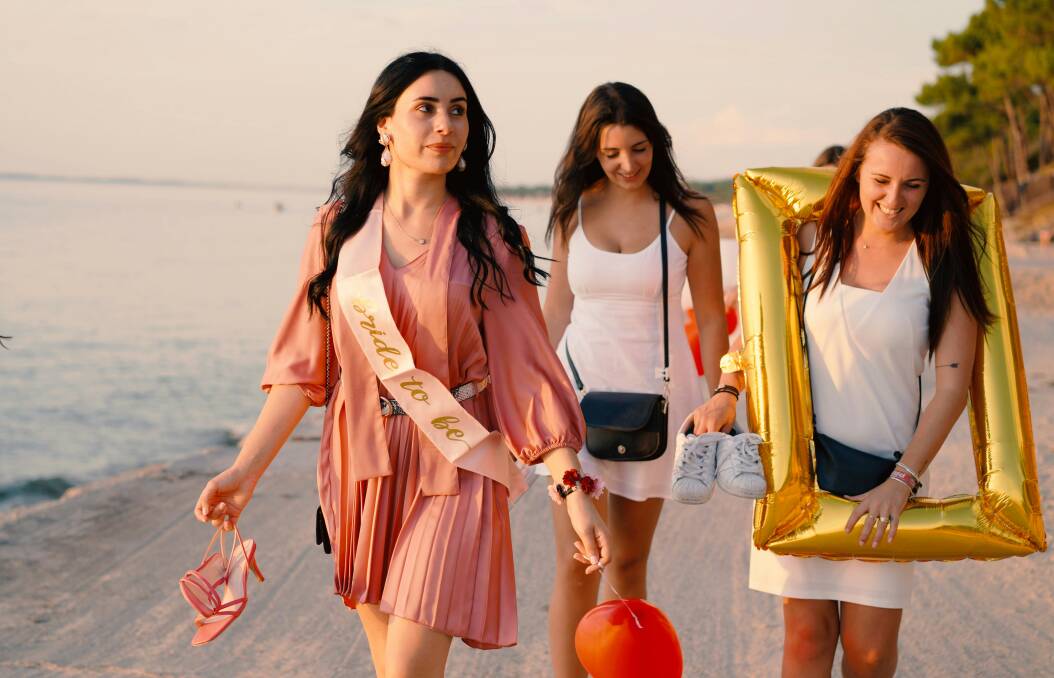 Friends at a hens' party walk on the beach. Picture Unsplash