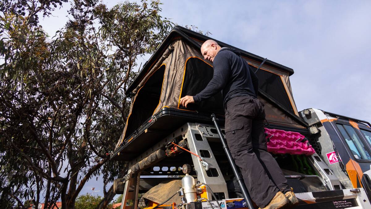 Simon Christie sets up a rooftop tent. Picture supplied