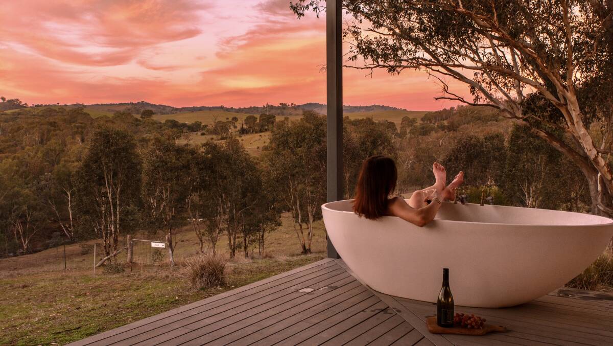 Jessica Ward unwinds in an outdoor bathtub at Kestrel Nest EcoHut.