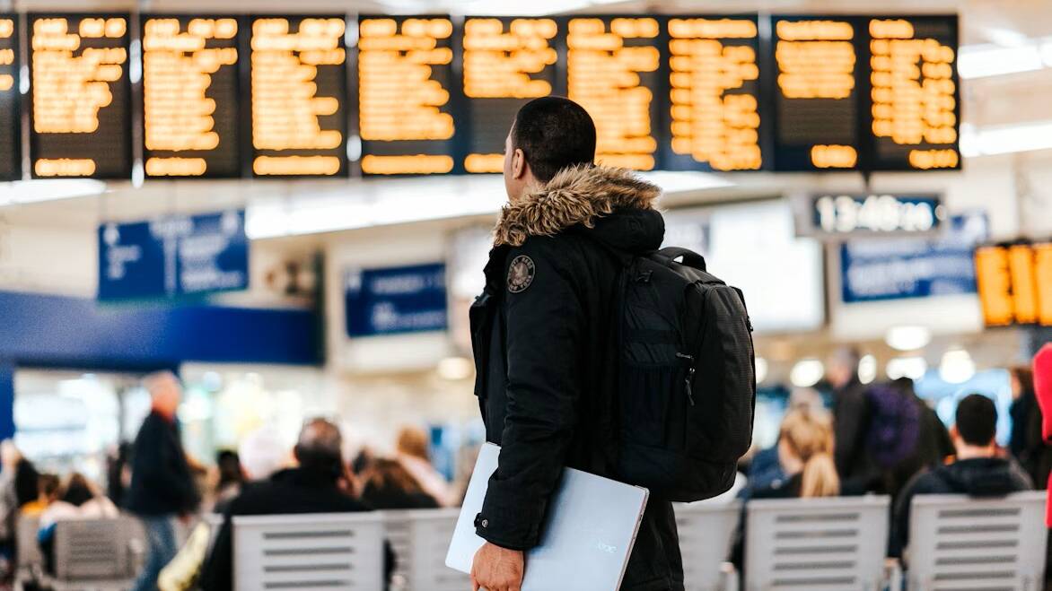 A man at an airport. Picture from Unsplash/Anete Lsia