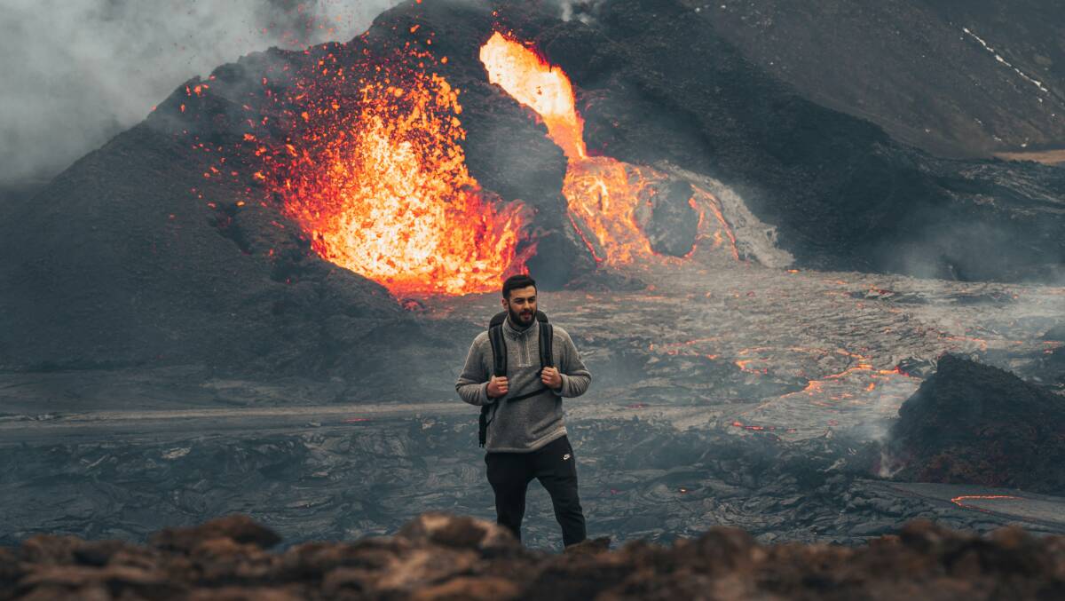 A man watches a volcano eruption in Iceland. Picture from Unsplash/Erik Chistov
