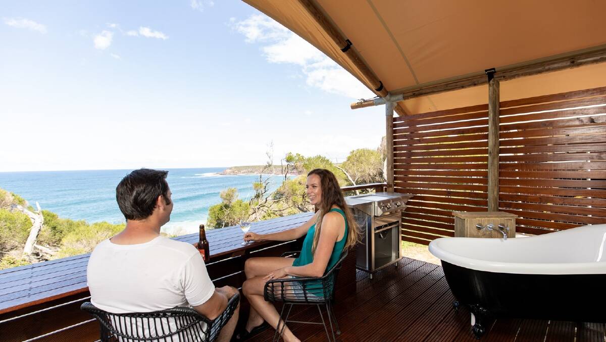 The private verandahs feature a built-in bar/dining area and even a bath where you can laze while you look out for whales. Picture: Destination NSW The private verandahs feature a built-in bar/dining area and even a bath where you can laze while you look out for whales. Picture: Destination NSW