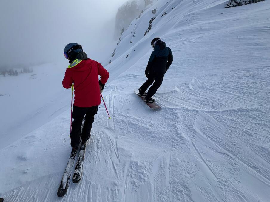 Guide Francois looks into the abyss after climbing into "the grey zone". Picture by Scott Hannaford