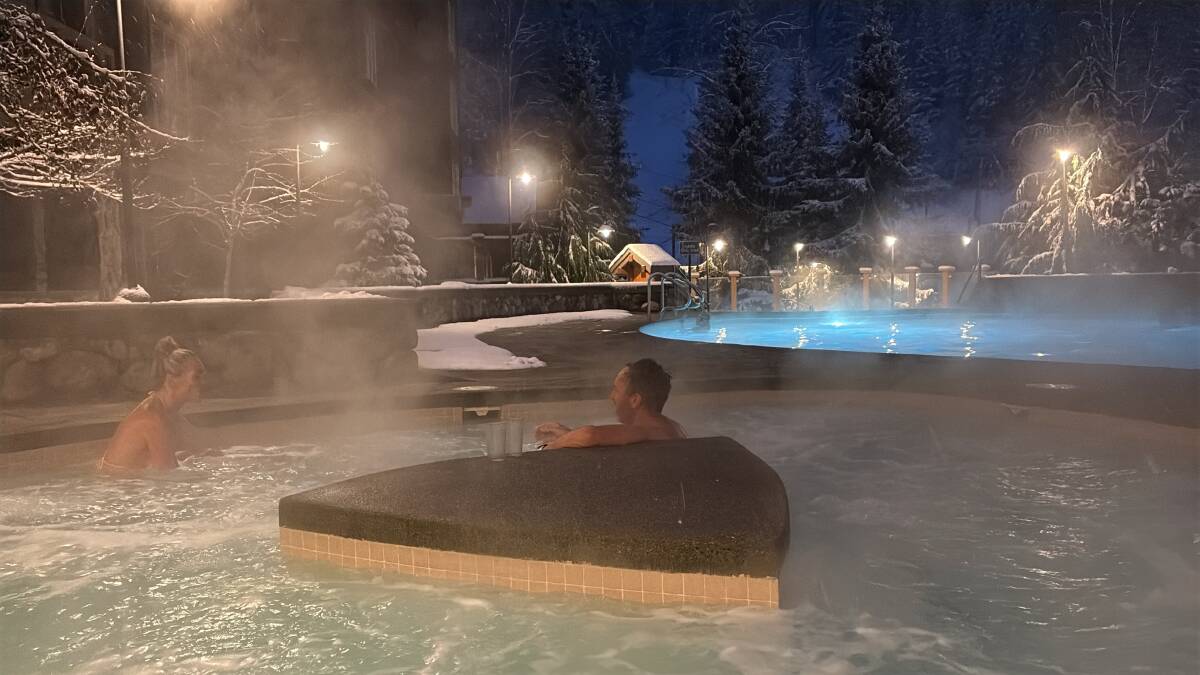 Relaxing in the outdoor hot pools at Legends hotel, Creekside. Picture by Scott Hannaford