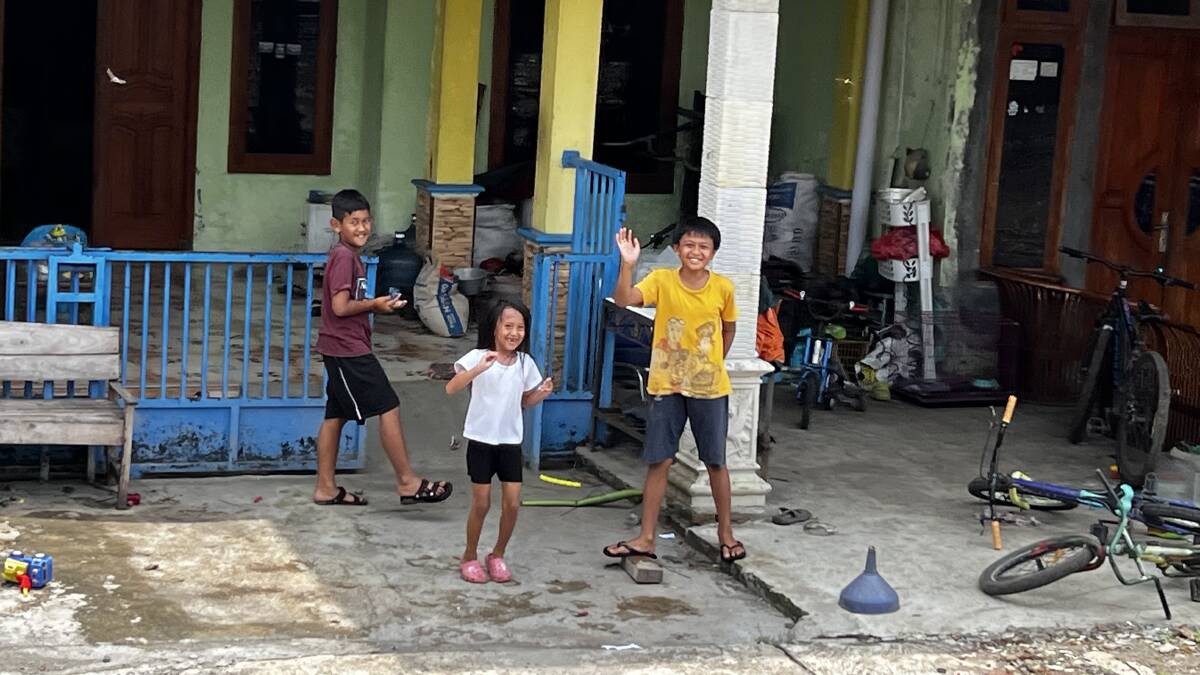 Children wave at the passing steam train in Ambarawa, near Semarang, Java. Picture: John Hanscombe