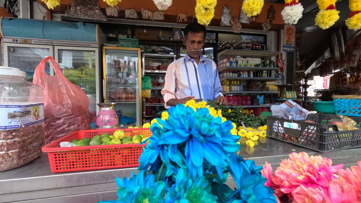 A garland maker at work in Little India. Picture: John Hanscombe A garland maker at work in Little India. Picture: John Hanscombe