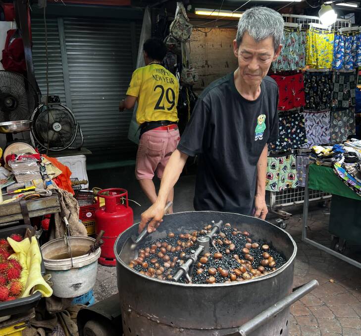 Chestnuts roasting in Kuala Lumpur's Petaling Street Market. Picture: John Hanscombe