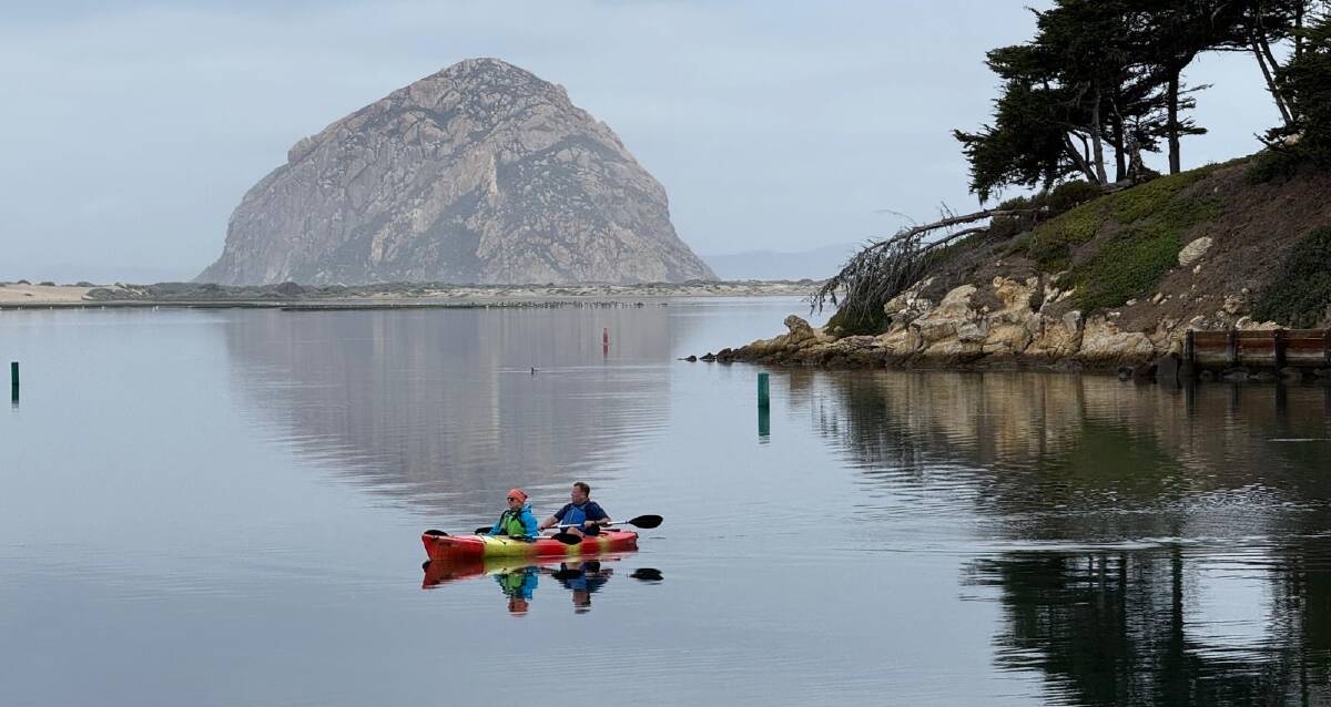Morro Rock provides a stunning backdrop for a kayaking tour on the glassy water of Morrow Bay.