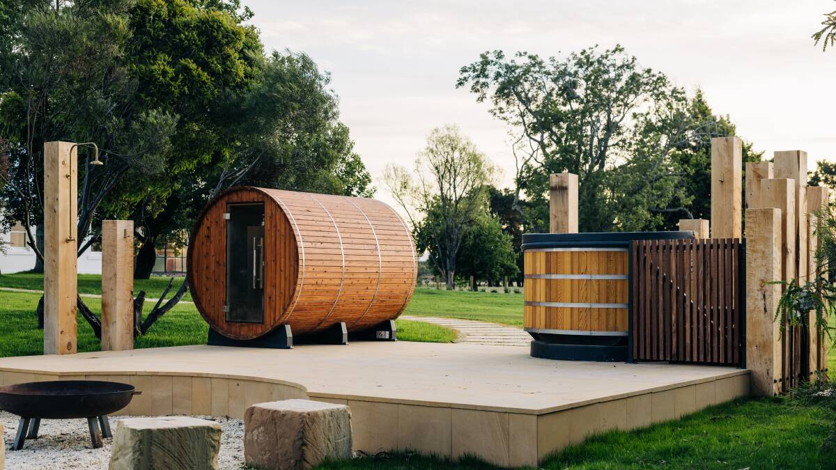 The outdoor spa bath and barrel sauna.