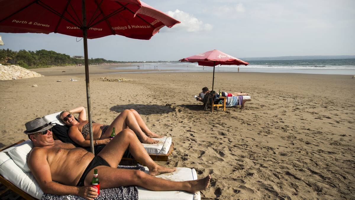 A couple relaxes at the beach. Picture by Shutterstock