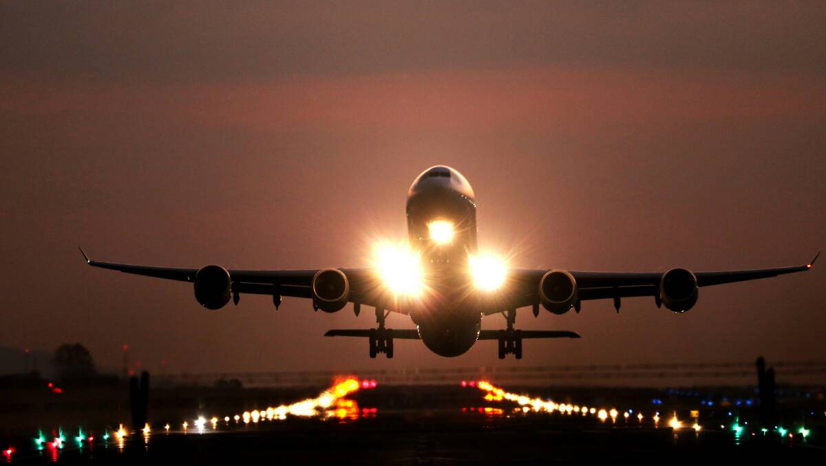 An aircraft takes off at night. Picture by Unsplash