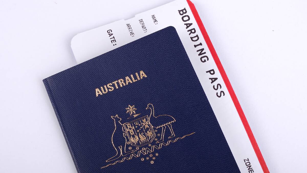 An Australian passport and flight boarding pass. Picture: Shutterstock An Australian passport and flight boarding pass. Picture: Shutterstock